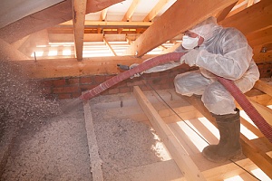 insulation specialist working on an attic