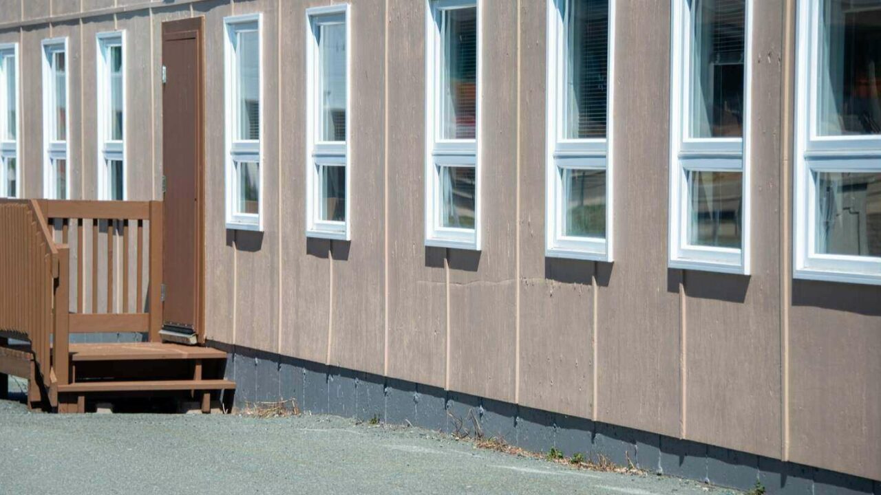 school building with multiple tall narrow windows with white trim