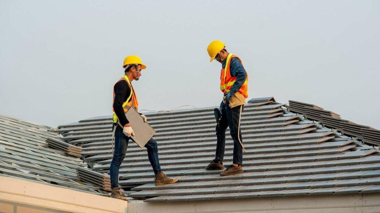 construction worker wearing safety harness belt during working on roof structure