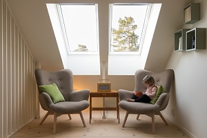 a child reading a book with the natural light from the skylight