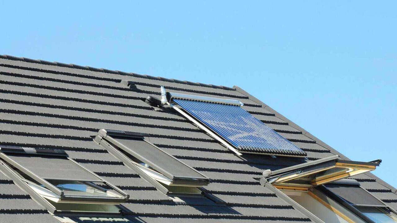 modern house roof with solar water heater and skylights