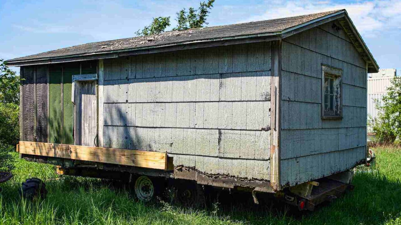 asbestos shingle houes on a trailer to be moved