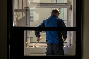 construction worker mounting new window