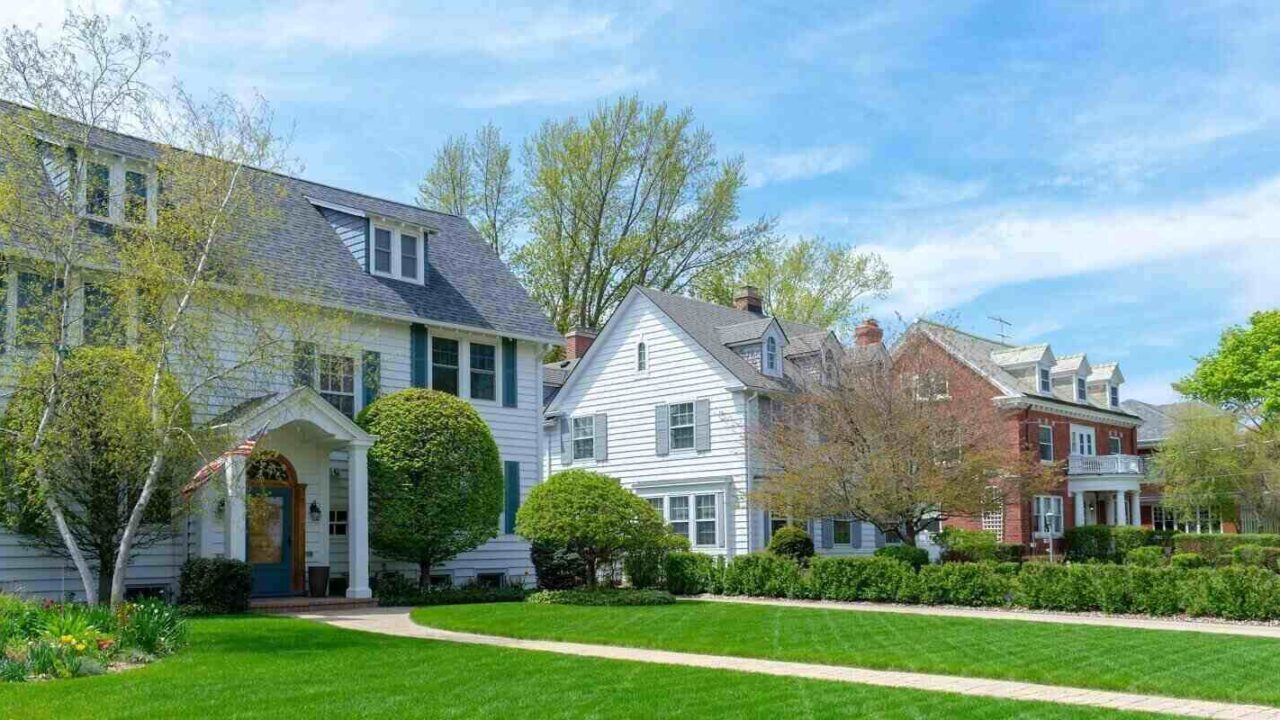 traditional suburban homes with green front lawns