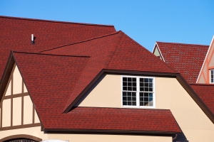 the house is covered with a red shingle material roof